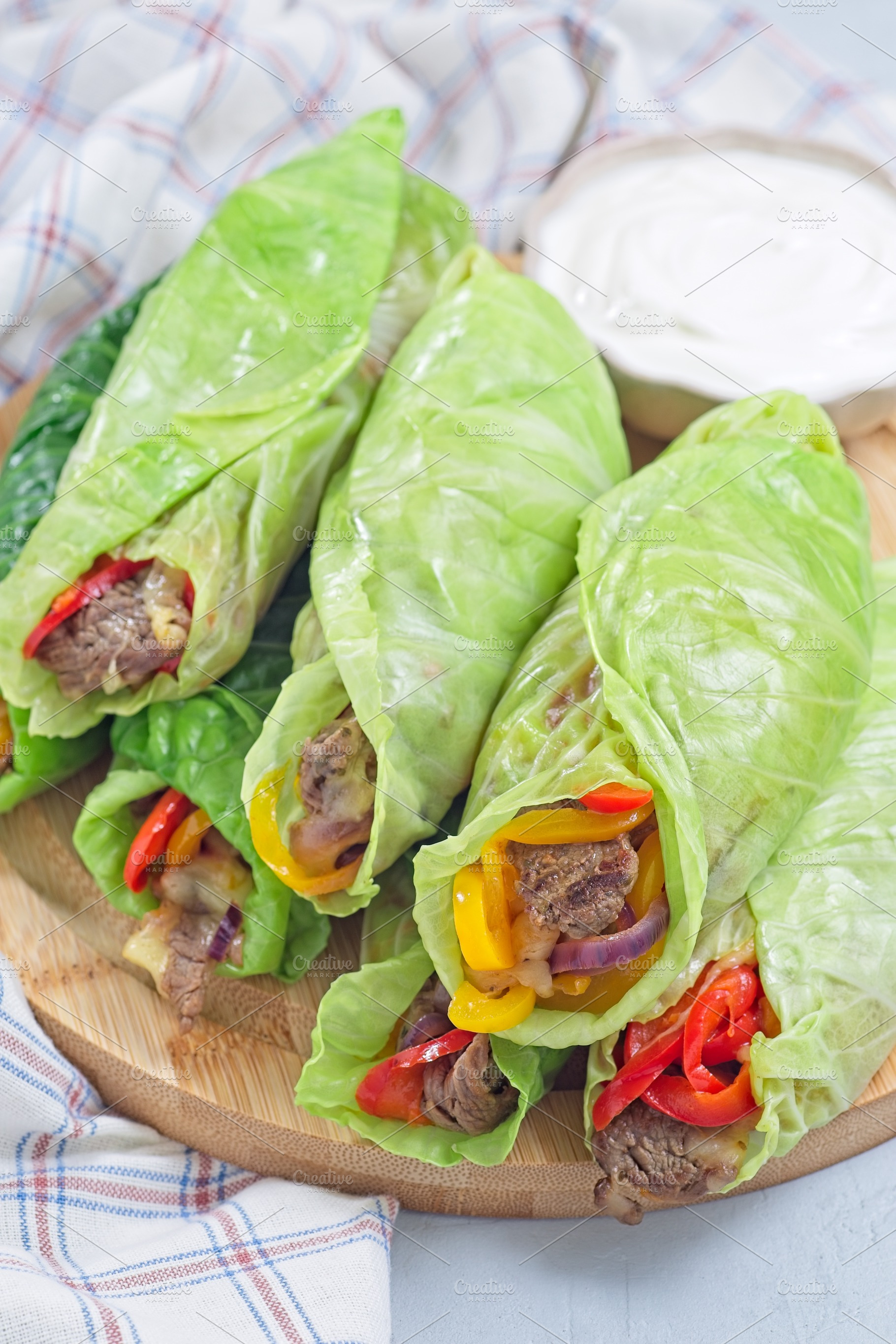 Healthy cabbage leaves wraps with beef, vegetables and cheese, served with plai, a Food & Drink Photo by iuliia_n