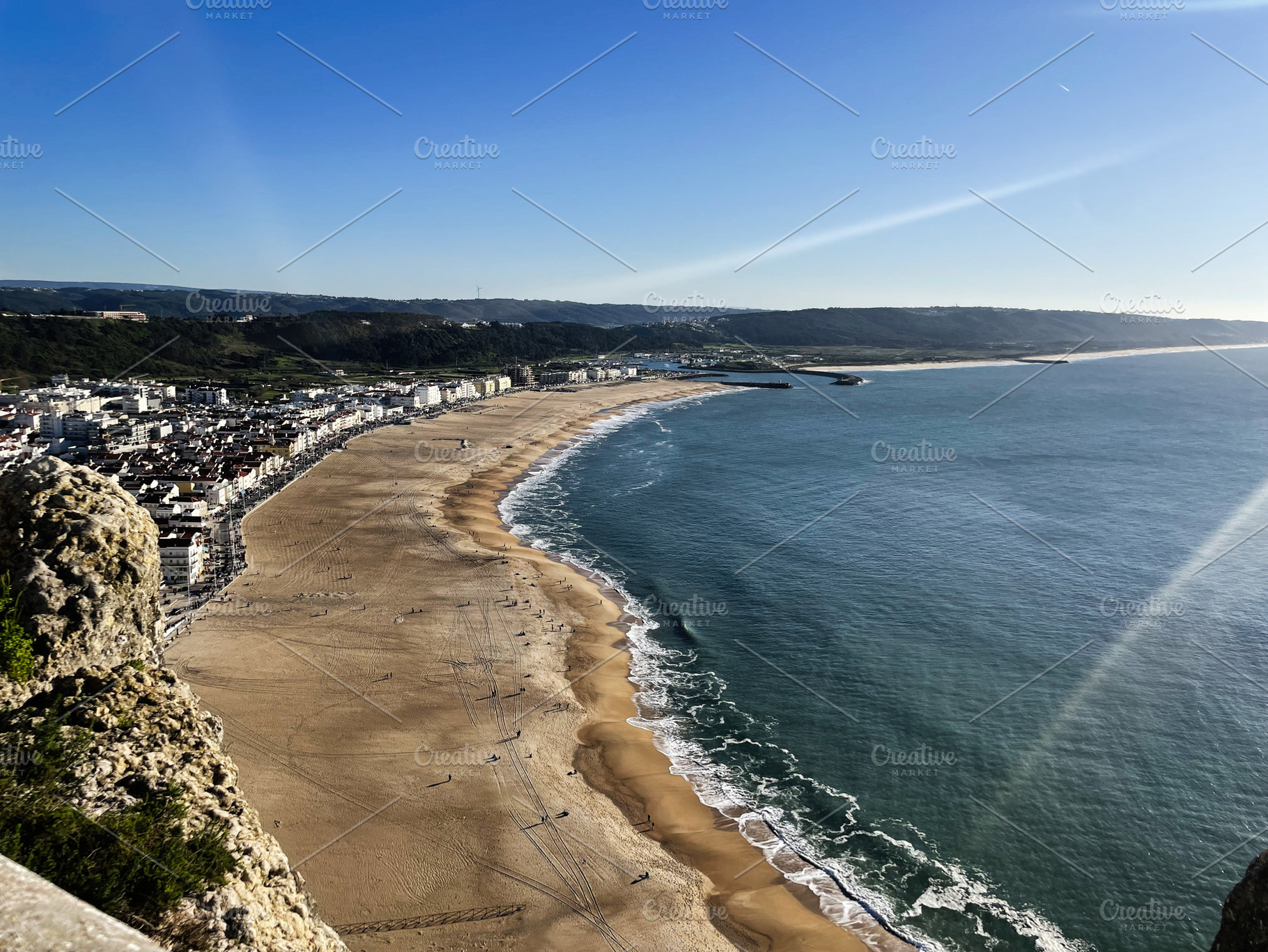 Panoramic view of Nazare beachfront and coastline under sunny sky, Portugal, a Photo by AS photostudio