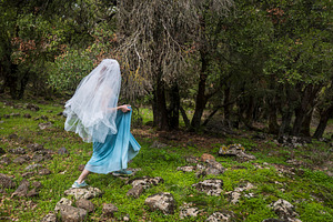 Mysterious woman in a blue dress and, a Person Photo by Imaginarium