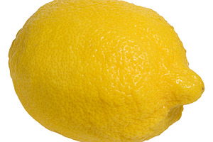 Whole lemon with a yellow, textured peel, isolated background, a Food & Drink Photo by ndanko