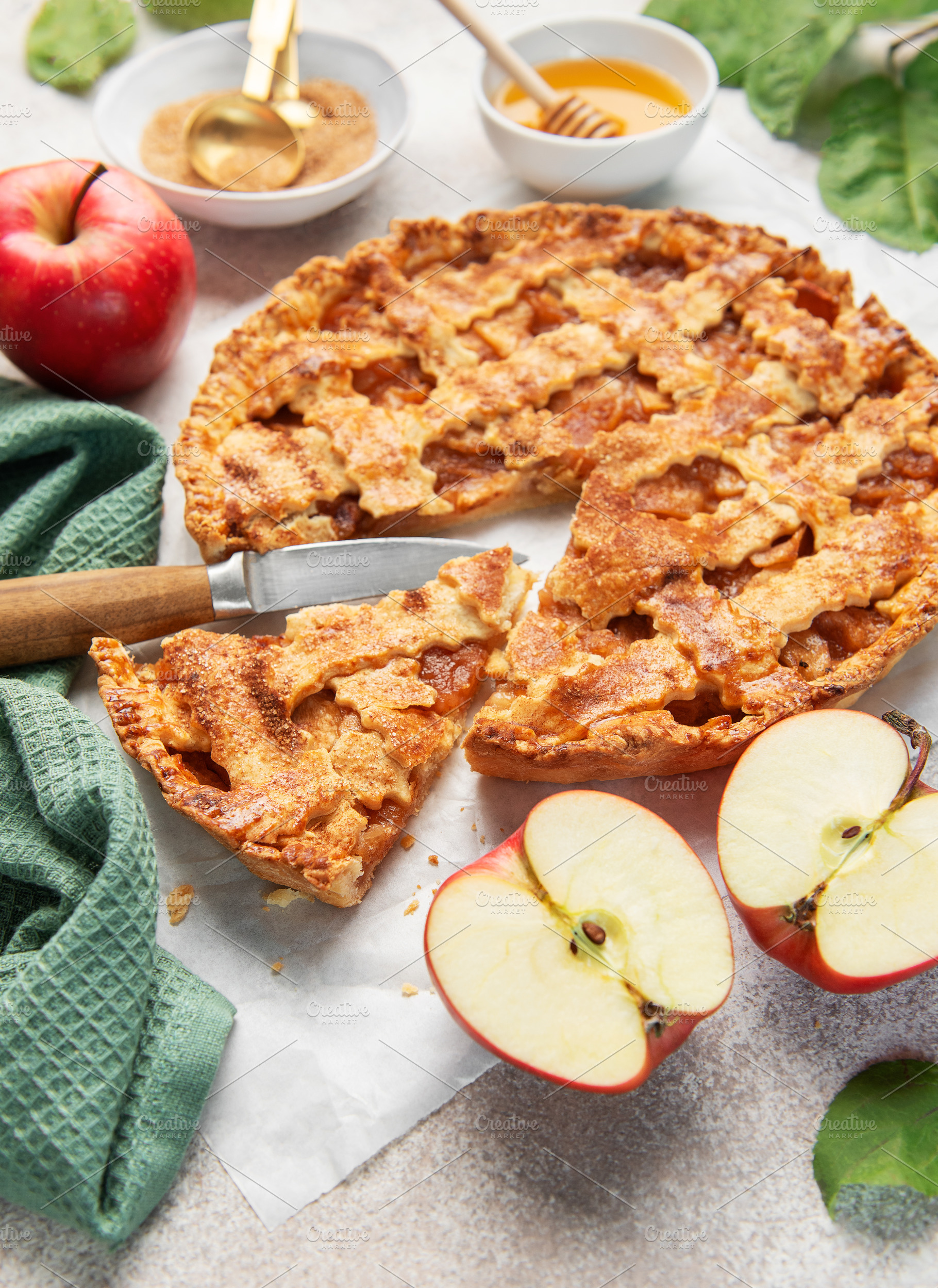 Homemade apple pie with ingredients on concrete background, a Food & Drink Photo by Olena Rudo