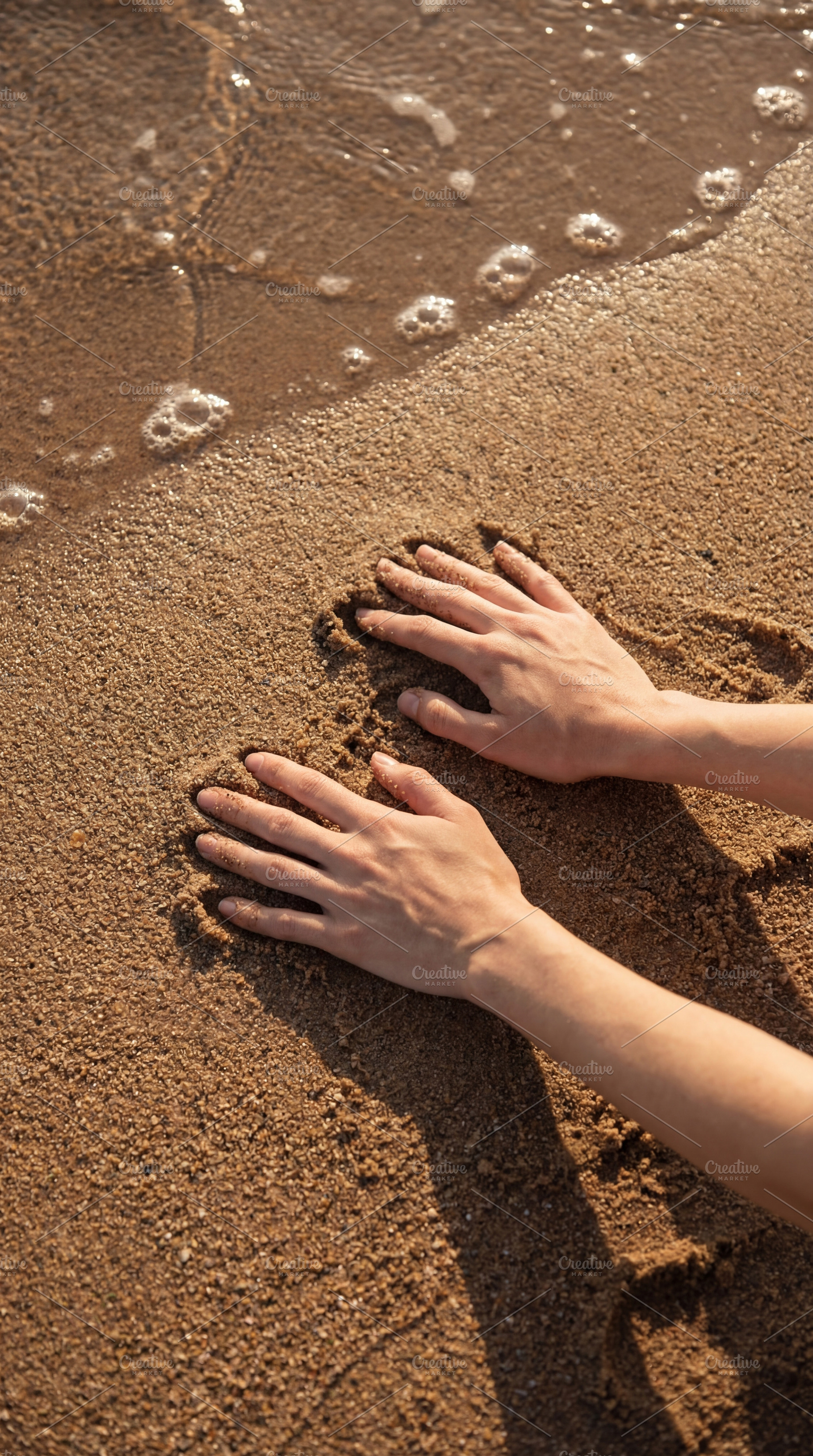Hands Pressed into Golden Sand, a Nature Photo by Virgo Studio