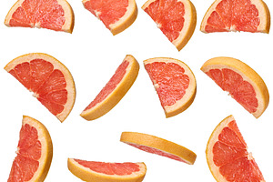Round grapefruit halves with juicy pulp and zest in different an, a Food & Drink Photo by ndanko
