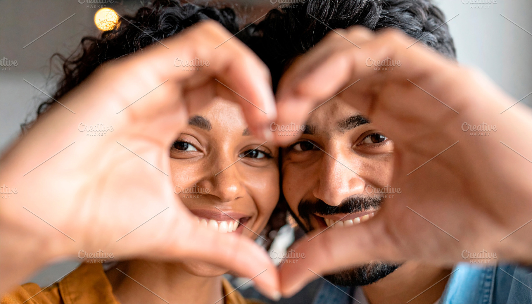 Happy diverse couple forming heart shape, a Person Photo by Davizro's Market