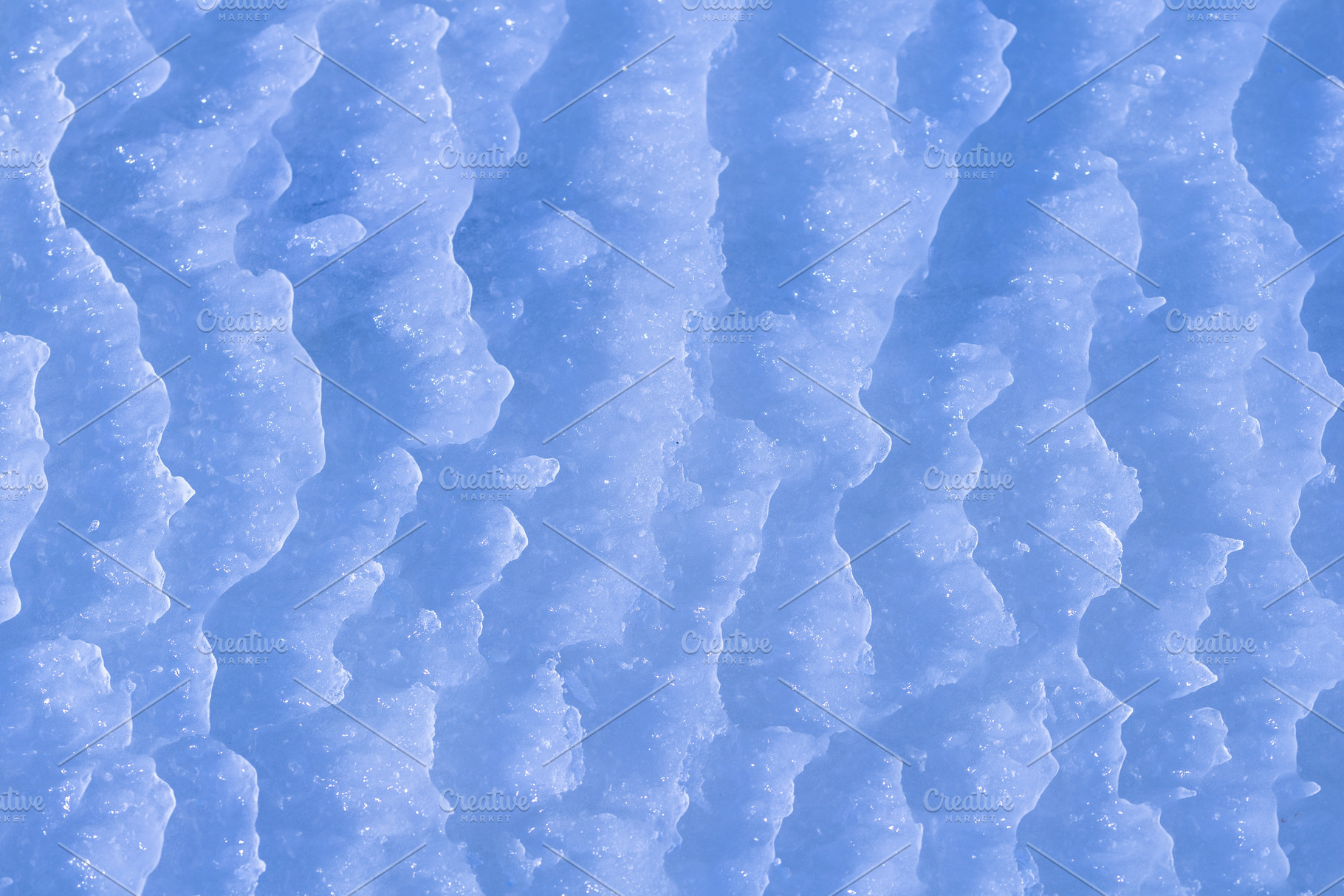 Blue rough ice texture with snow, winter background, a Photo by MDBildes