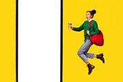 Shocked Black Teenager Girl Jumping Near Smartphone Screen, Yellow Background, a Photo by Prostock-Studio (Thumbnail 6 of 8)