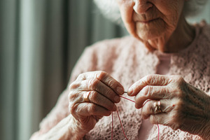 Elderly woman threading needle, a Person Photo by Virgo Studio