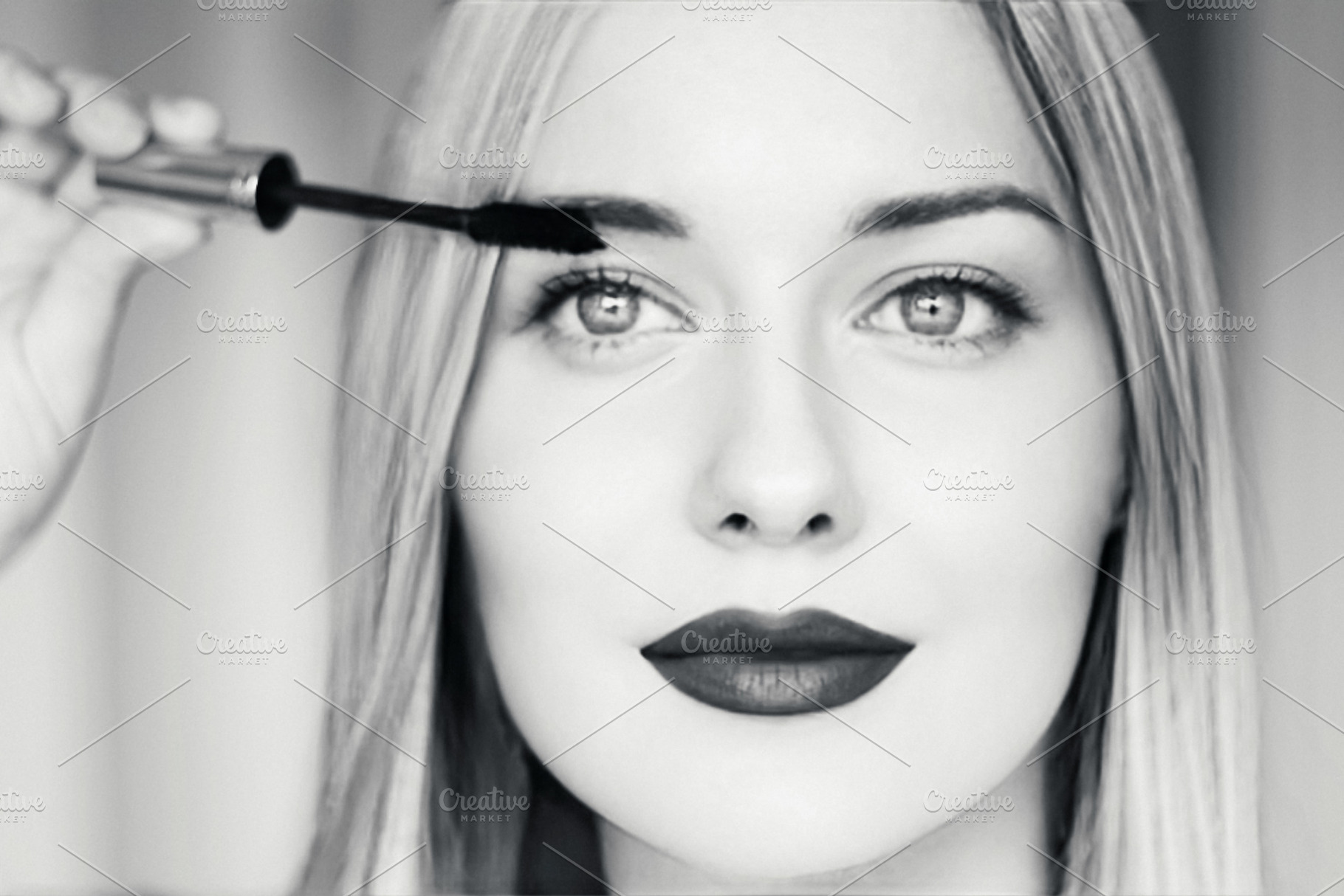 Beautiful blonde woman applying mascara, with dark lipstick, bri, a Person Photo by Studio ANNA