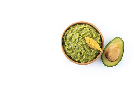Mexican guacamole with nacho chip isolated on white background, a Food & Drink Photo by etorres69