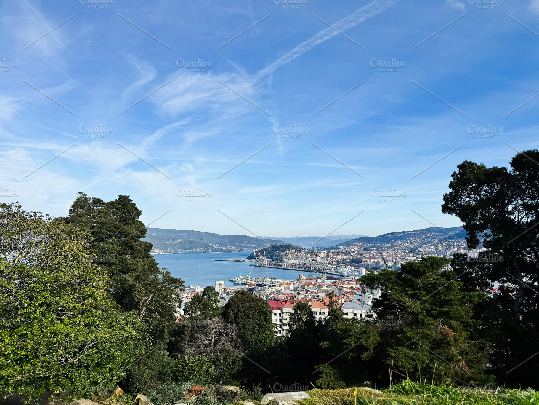 Panoramic view of Vigo cityscape and harbor surrounded by lush greenery, Spain, a Photo by AS photostudio