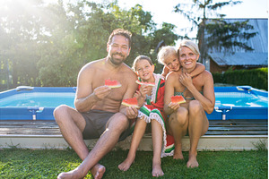 Family with two children in swimwear, a Person Photo by HalfPoint