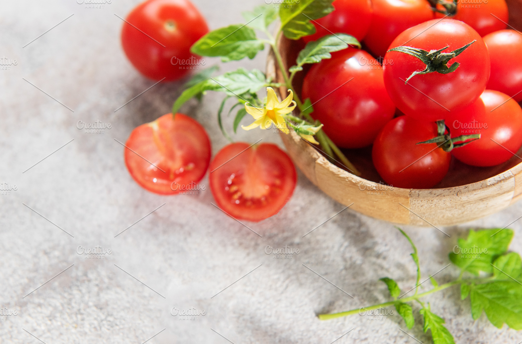 Fresh ripe cherry tomatoes with leaves and flower, a Food & Drink Photo by Olena Rudo