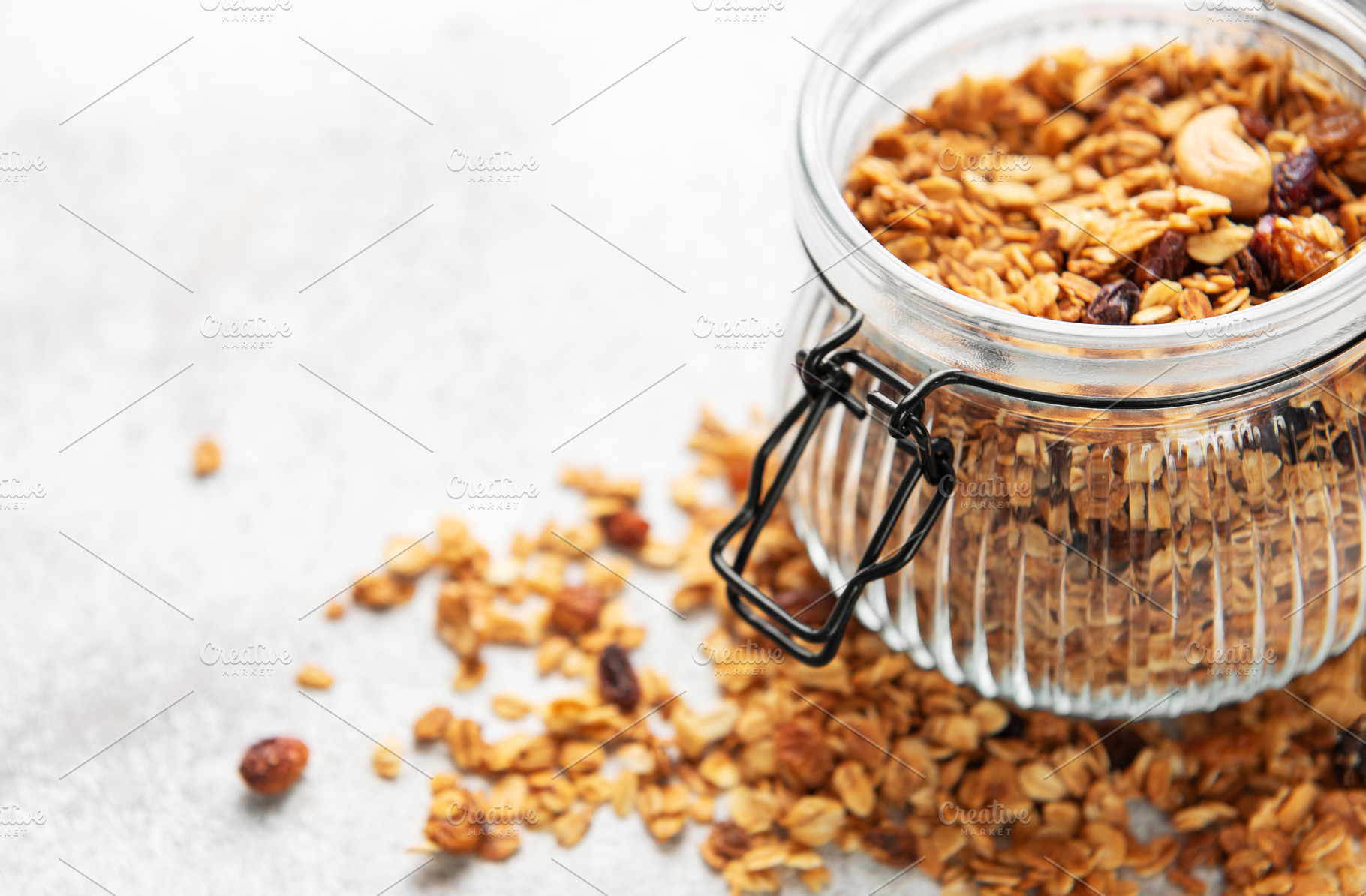 Granola cereal in glass jar for healthy breakfast, a Food & Drink Photo by Olena Rudo