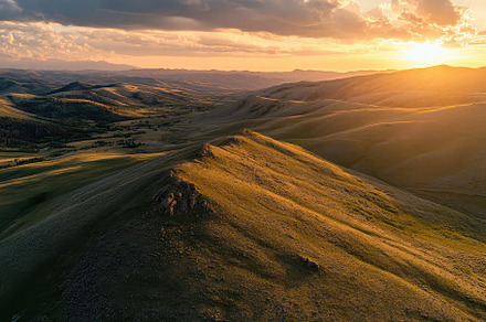 Sunset casts an orange glow over gra, a Photo by Iftikhar Alam