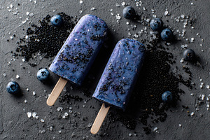 Blueberry pops on dark stone, a Photo by Beautiful things