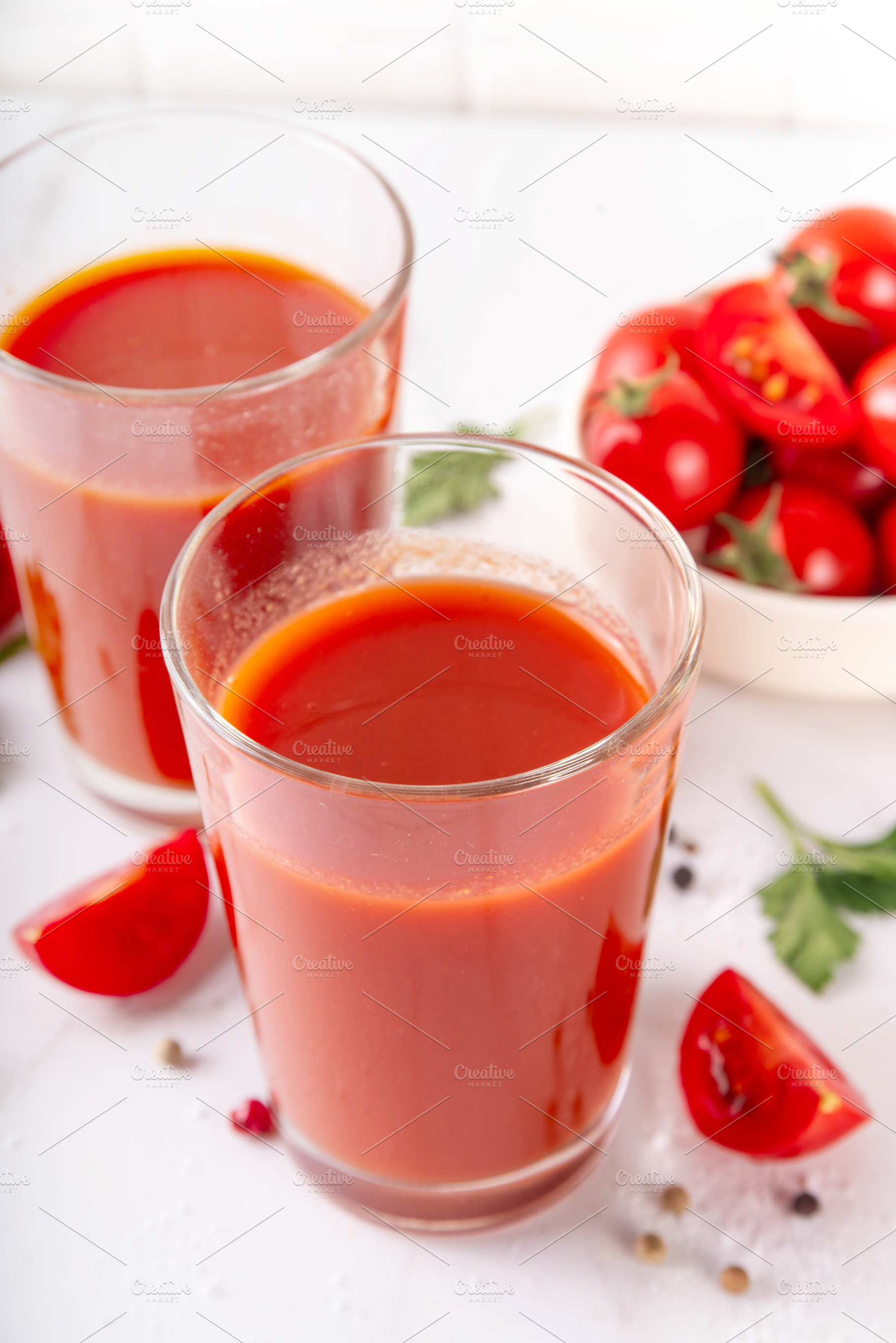 Tasty salted tomato juice in two glasses with fresh ripe tomatoe, a Food & Drink Photo by Rimma