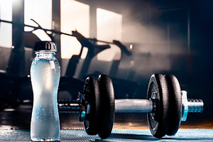 Barbell and water on blue mat in a gym backlit, a Sports & Recreation Photo by Davizro's Market