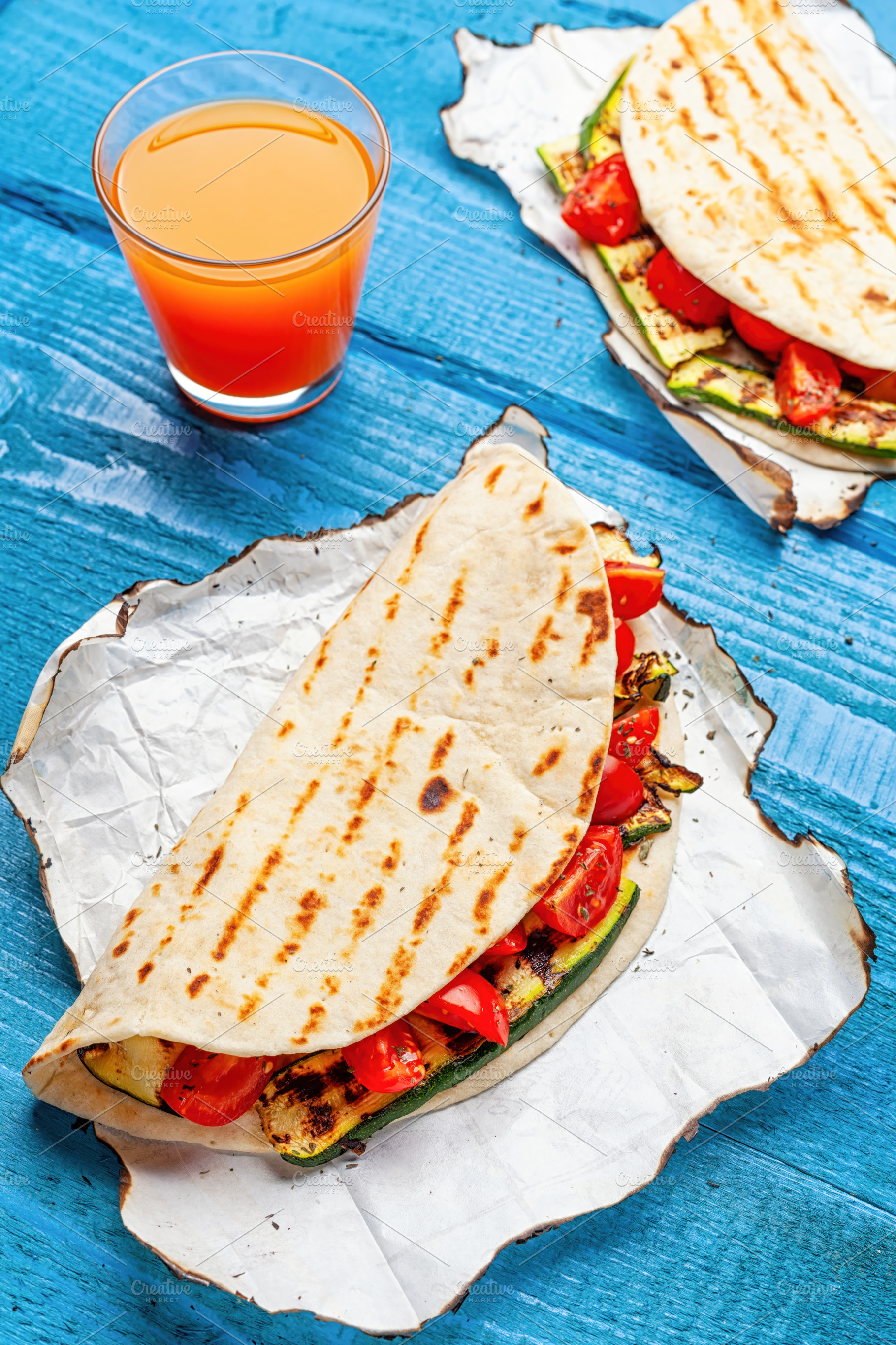 Piadina with grilled zucchini and tomatoes served with orange juice, a Food & Drink Photo by Antonio Gravante Market