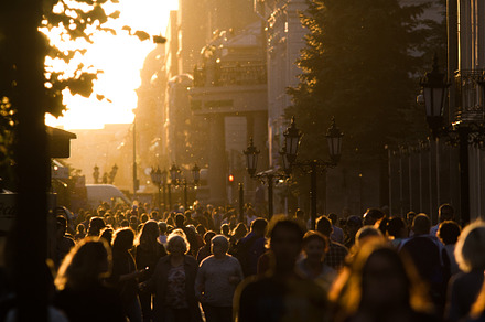 Silhouette crowd of people walking down the pedestrian zone at summer evening sunset, a Person Photo by Barcelona_dreams
