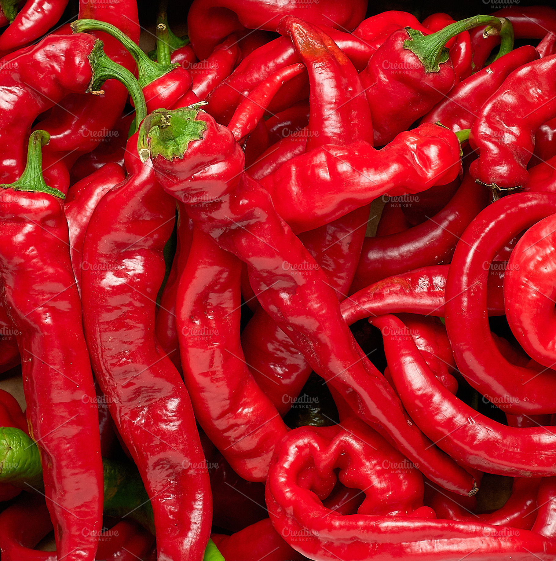 Fresh ripe red chili peppers lie in a tight pile., a Food & Drink Photo by ndanko