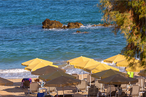 Beach with yellow umbrellas on the