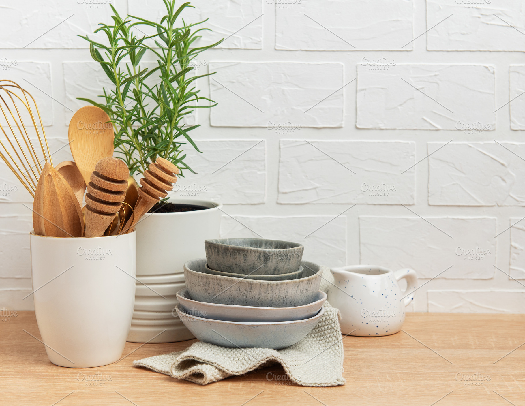 Kitchen utensils, rosemary plant, and ceramic bowls creating a c, a Food & Drink Photo by Olena Rudo