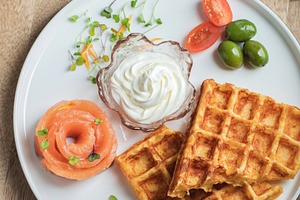 Crunchy waffle fries with sour cream dip served in a basket, a Food & Drink Photo by Budarinphoto