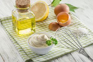 Bowl with mayonnaise sauce in the centre and mayonnaise ingredie, a Food & Drink Photo by Volff