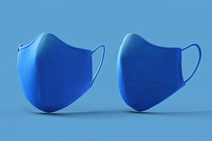 Two blue fabric face masks mockup on a blue background, a Mask Mockup by Textures & Backgrounds