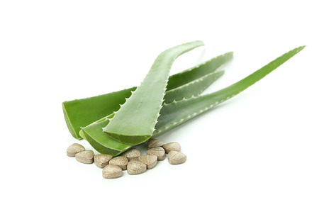 Concept of herb pills with aloe isolated on white background, a Beauty & Fashion Photo by AtlasStudio PRO