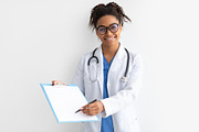 Portrait of black doctor looking at camera showing clipboard, a Photo by Prostock-Studio (Thumbnail 2 of 3)