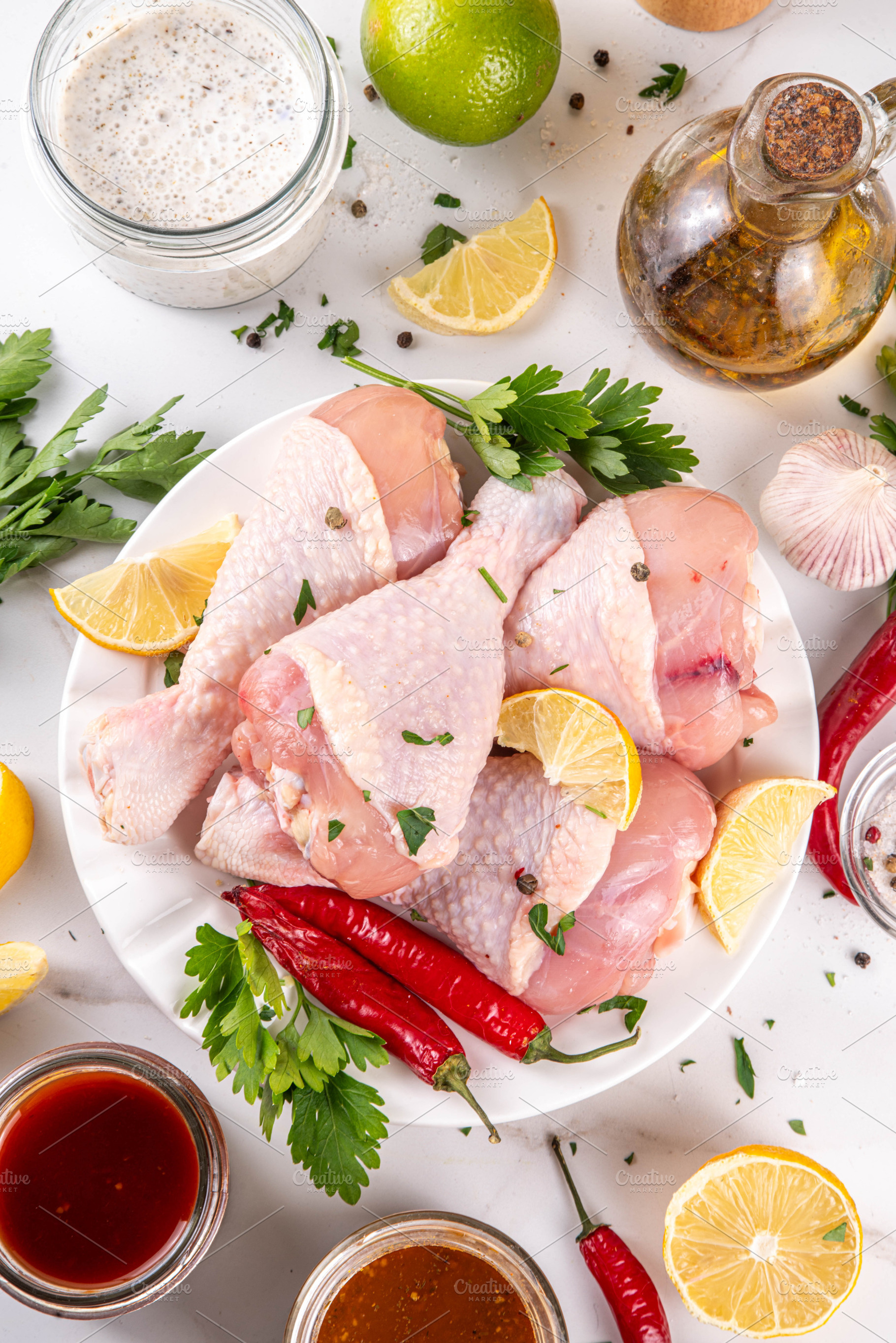 Fresh raw organic chicken legs, drumsticks, with spices and cond, a Food & Drink Photo by Rimma