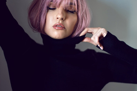 Close up portrait of a woman with pink hair and a black sweater on background i, a Person Photo by SaulichPhoto