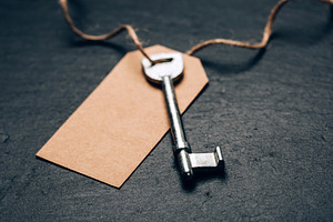 Key with blank tag on slate, a Business Photo by Anna Efetova