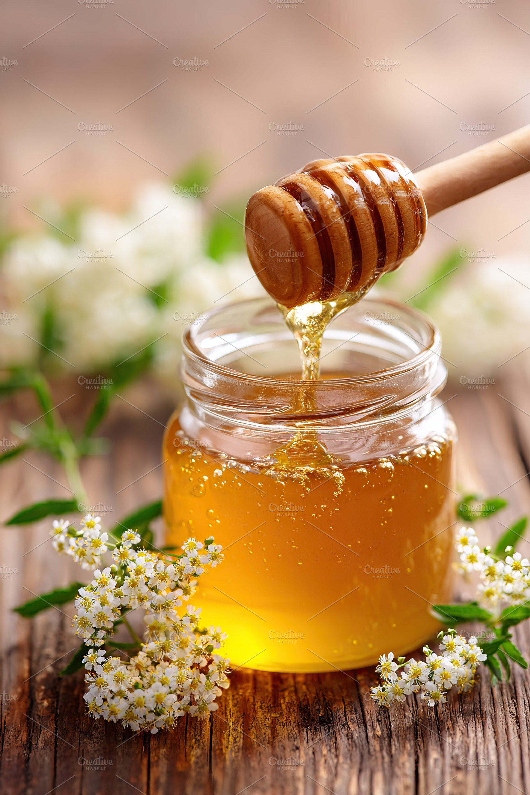 Close-up of a glass jar filled with honey and a wooden dipper on a rustic woode, a Photo by AlyaAnd