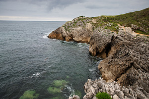 Rocky cliff with natural cave and th, a Nature Photo by Perpis