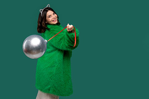 Woman in green coat smiles, a Person Photo by Elena Vagengeim
