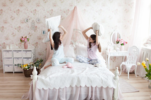 Mother and daughter pillow fight
