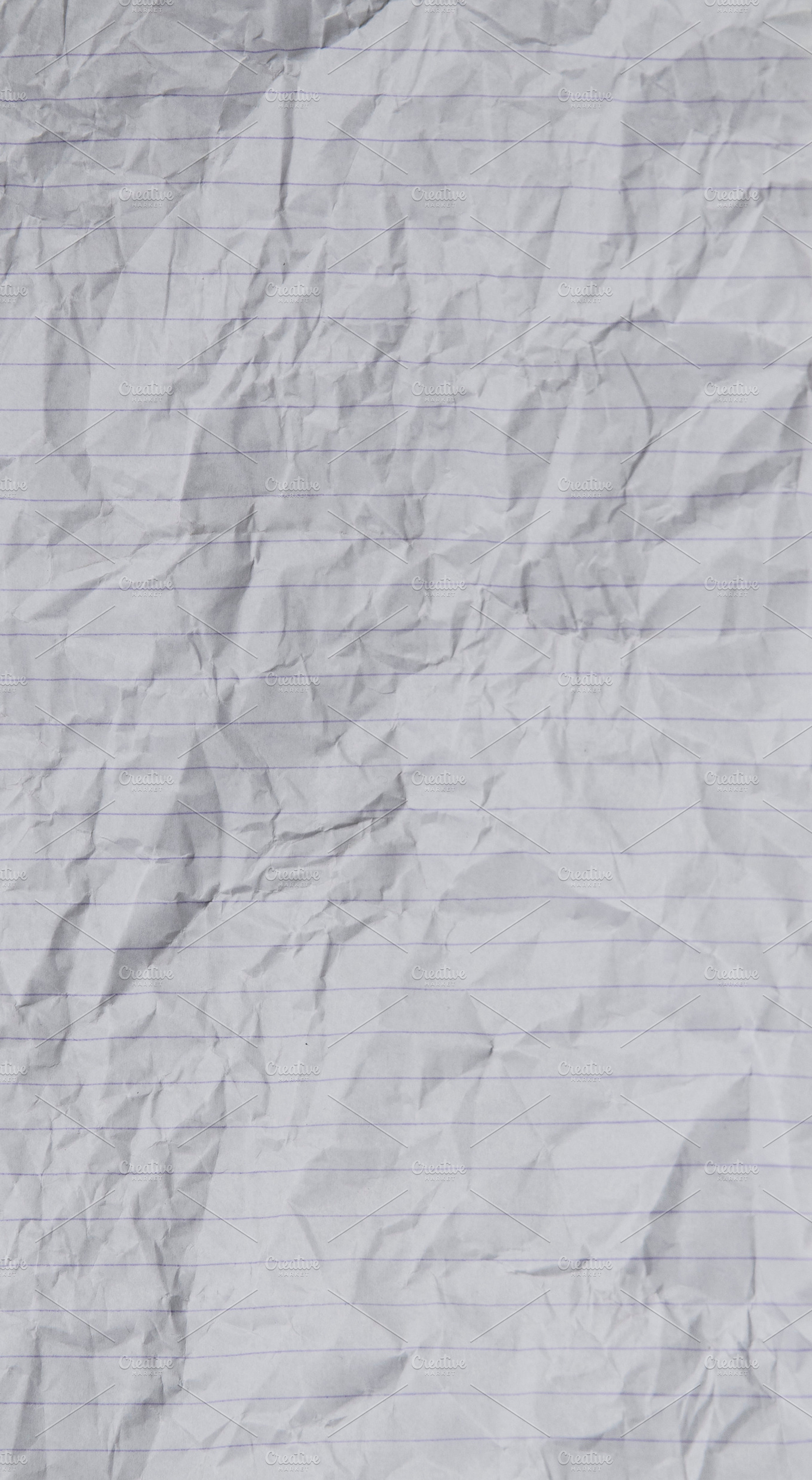 White crumpled lined paper, a Photo by Floor