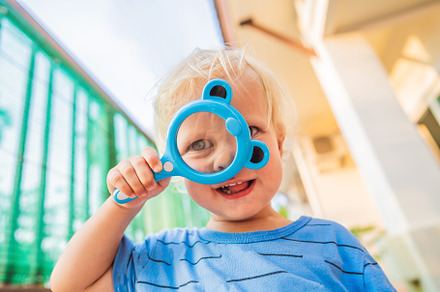 Boy looking in a magnifying glass stock photo containing boy and child, a Person Photo by Elizaveta Galitskaya