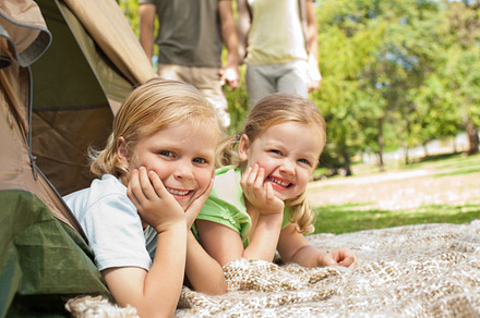 Happy family camping in the park, a Photo by wavebreak