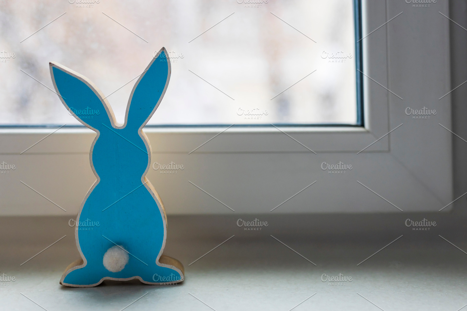 Blue wooden bunny figurine standing, a Holiday Photo by Imaginarium