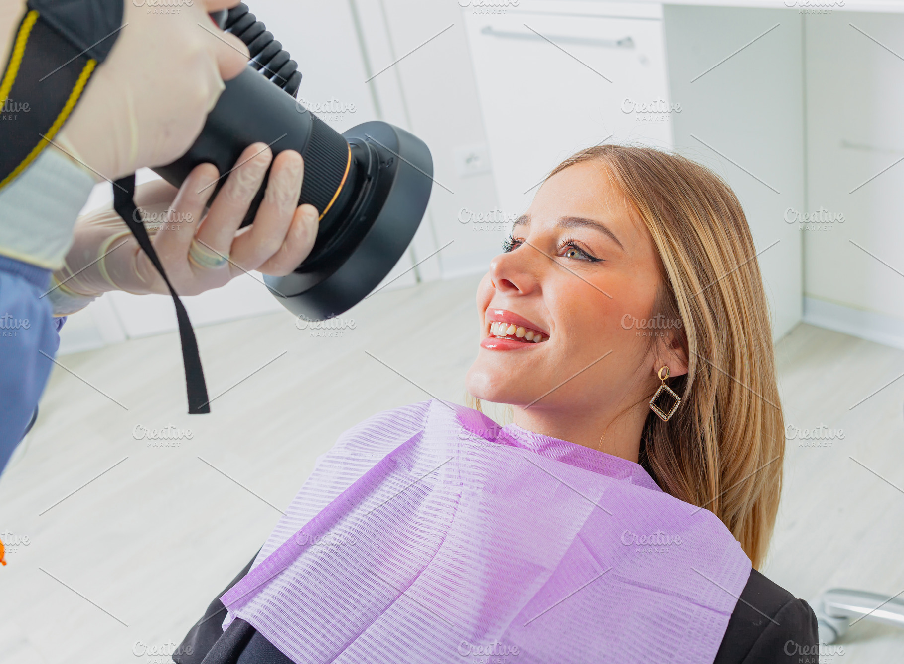 Dentist taking pictures of patient's teeth with professional camera in dental c, a Health & Medical Photo by Antonio Gravante Market