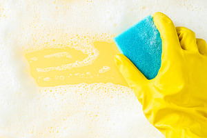 Cleaning concept - foam frame and cleaning sponge on bright background