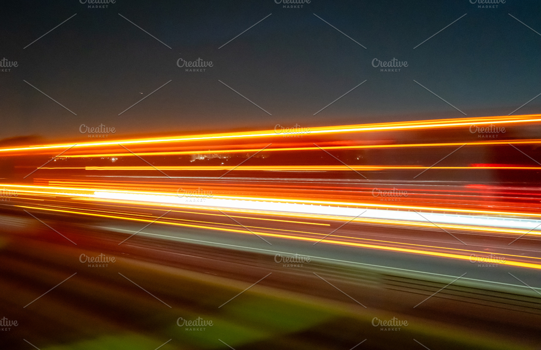 Light trails of a moving vehicle at night on the road, a Nature Photo by GoodGoods