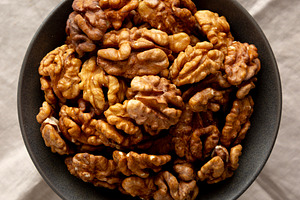 Raw Walnut Halfs in a Bowl, top view. Flat lay, overhead., a Food & Drink Photo by LiudmylaChuhunova
