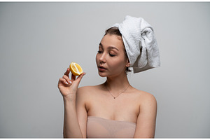 Woman with hair wrapped in a white, a Health & Medical Photo by volodymyrshtun13795