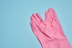 A pair of pink rubber gloves on a blue background, a Background Photo by ndanko