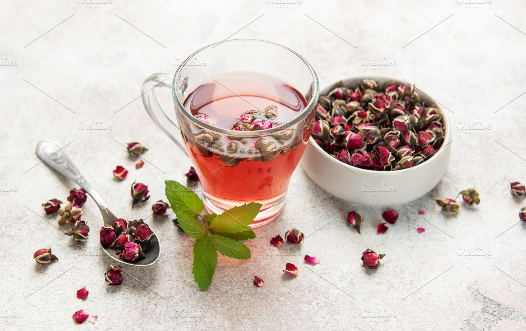 Rose tea infusion with dried buds and fresh mint leaf, a Food & Drink Photo by Olena Rudo