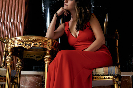 young brunette woman sitting with a red dress in the living room, a Beauty & Fashion Photo by YossSabalet